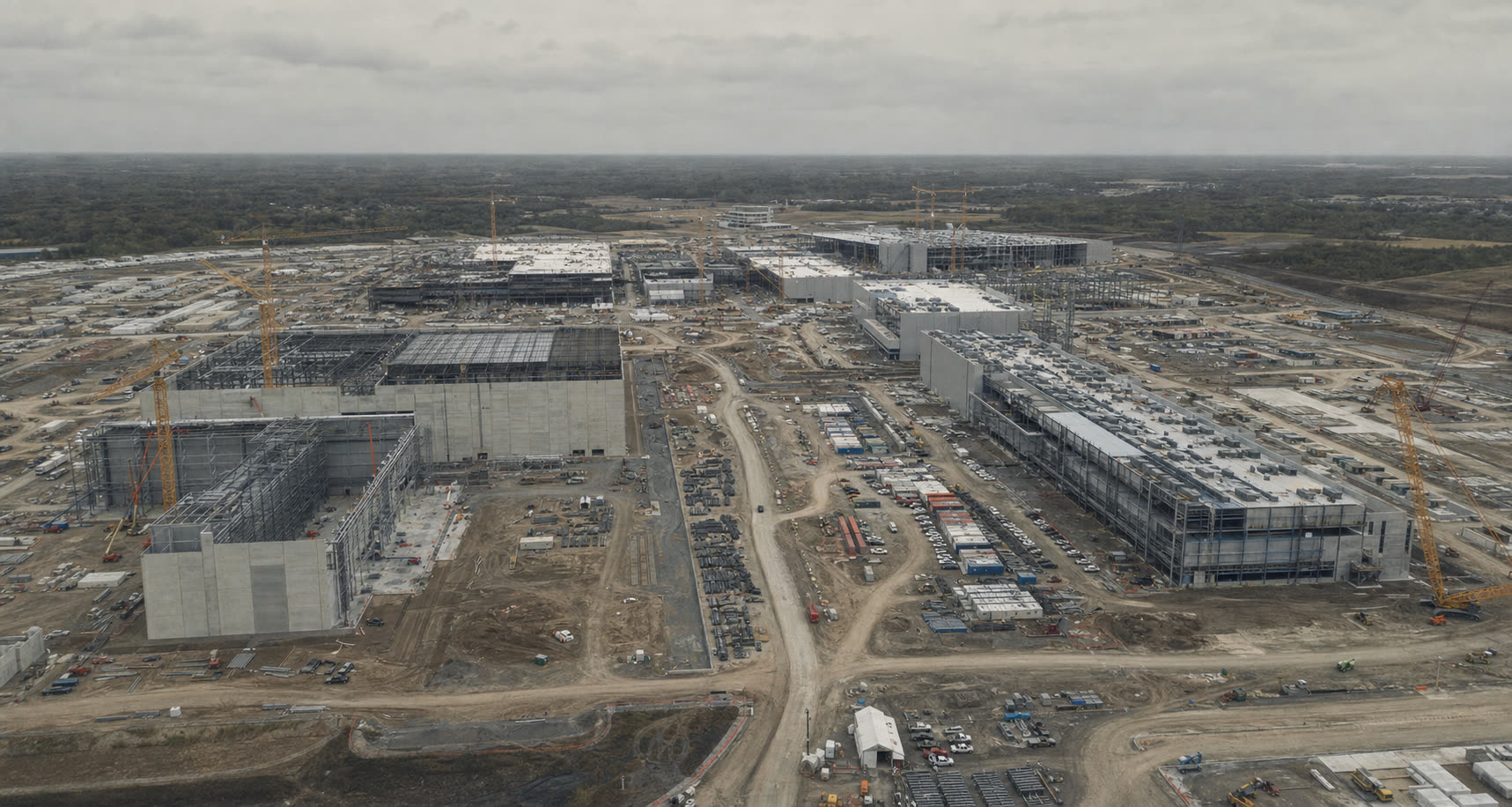Elevated view of a large multi-building data center campus under construction.